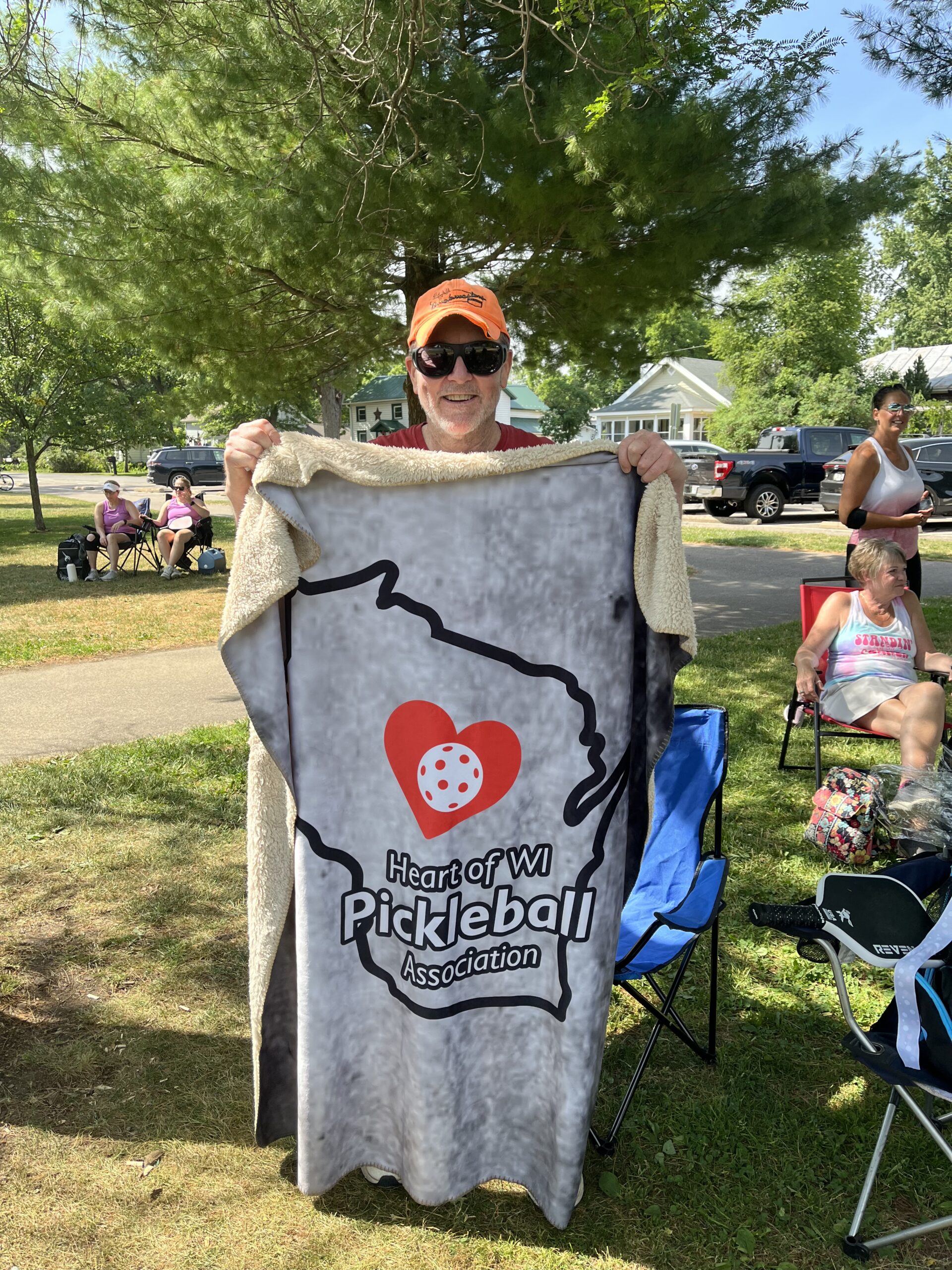 HOWPA member holding up blanket with HOWPA logo